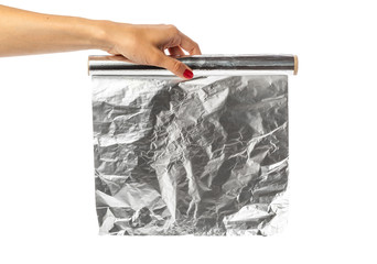 human hand holding a roll of foil on a white background