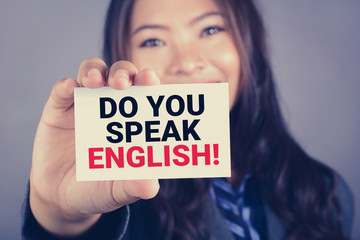 DO YOU SPEAK ENGLISH! , message on the card shown by a young woman
