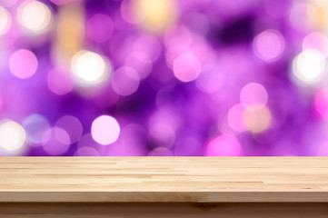 Wood table top on colorful purple bokeh abstract background