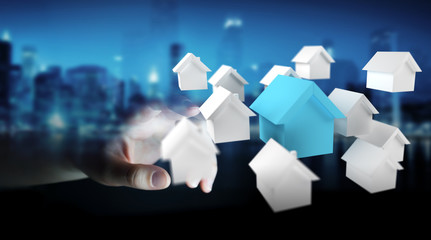 Businessman using 3D rendered small white and blue houses
