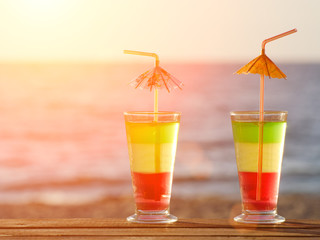 Couple of colorful cocktails on the beach and the sea, toning