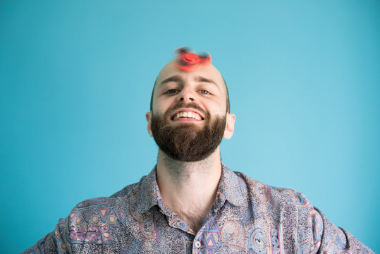 Excited man with spinning toy on head