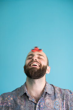 Excited man with spinning toy on head