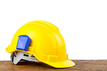Yellow safety helmet on wood background