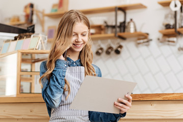 Pretty teenage barista making business calls