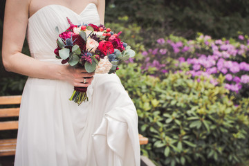 The bride is holding a wedding bouquet