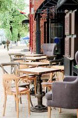 Obraz premium Chairs and tables on summer terrace on outdoor cafe