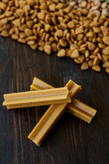 Dry pet food on black wooden table.