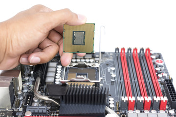Hand holding CPU show  the ic surface and have motherboard open socket mount for cpu isolated on...