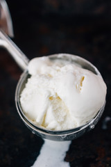 Ice cream starting to melt in metal ice cream scoop.