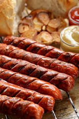 Grilled sausages in oven pan with garlic and onion