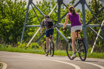 Naklejka premium Bikers ride on the road in the park