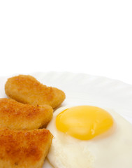 Fried egg and nuggets on plate copy space