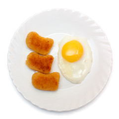 Fried egg and nuggets on the plate