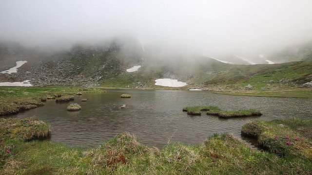 Mountain lake with fog timelapse