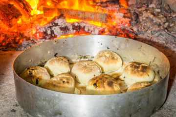 Delicious food in oven with firewood