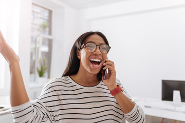 Happy joyful woman speaking on the phone