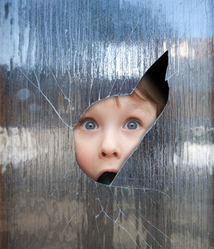 child looks through a window