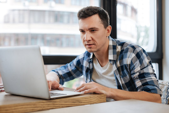 Energetic committed student searching for something online