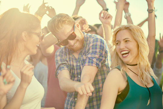 Big group of people dancing and having a good time at music festival