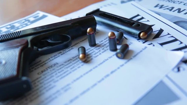 An announcement about the search for a criminal on the table of the bounty hunter, a combat pistol, cartridges