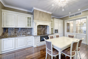 Modern design white kitchen in a spacious apartment.