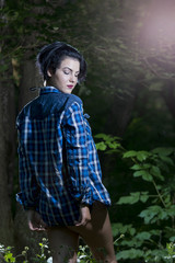 Pretty young girl posing outdoor in a forest