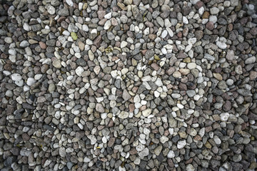 Textures of little white stone rocks on a floor.