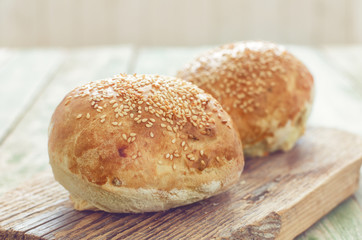 Fresh buns for burger on wooden table. Close-up