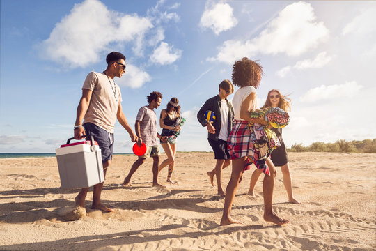 Multiracial Group Of Friends Walking At Beach