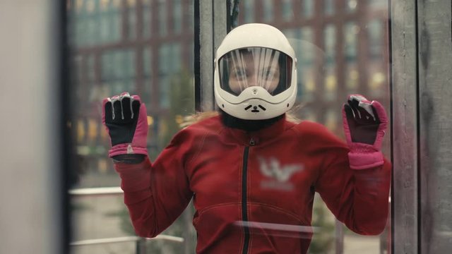 Young skydiver woman getting ready for flight in wind tunnel