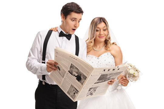 Newlywed couple reading a newspaper