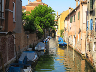 20.06.2017, Venice, Italy: Canal with boats and colorful facades of medieval houses