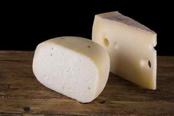 variety of Italian cheese on wooden cutting board