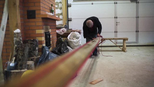 Master works with sailboat mast and ropes indoor workshop wide