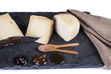 variety of cheeses served with honey and jams
