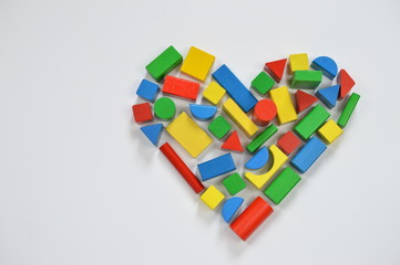 colorful wooden toy blocks shaping the form of a heart