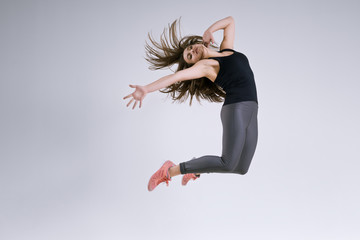 Naklejka premium Girl in jump on a gray background