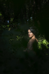 Pretty young girl posing outdoor in a forest 