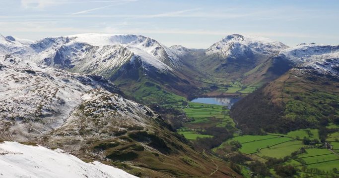 Winter views of snow covered mountains in the Eastern Fells of the English Lake District. Summits of Hartsop Dodd, Stony Cove Pike as well Brothers Water lake and the road, Kirkstone Pass.