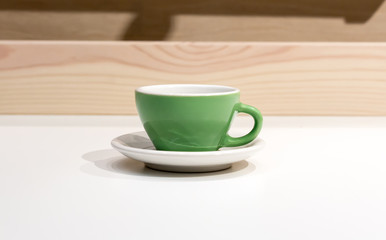 Empty green coffee or tea mug
