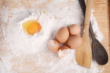 A dough with eggs and utensils.