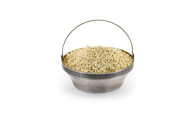 Bowl of pearl barley isolated on white background, side view