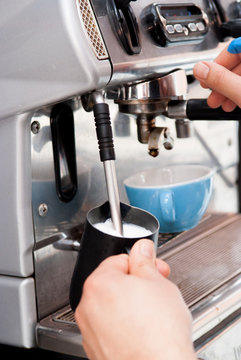 Pouring fresh coffee from the machine in the coffee shop