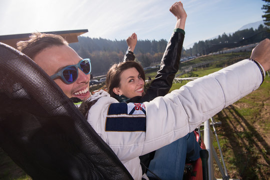 couple enjoys driving on alpine coaster