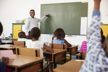 Teacher using chalkboard in a lesson at an elementary school