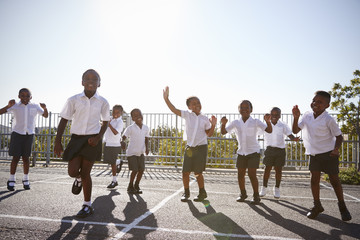 Elementary school kids having fun in school playground