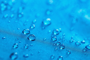 Rain Water droplets on  blue waterproof fabric