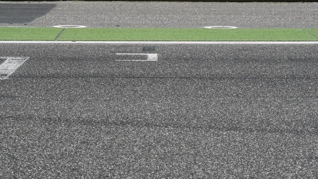 Motorsport circuit track straight start finish line and blurred car racing crossing frame
