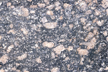 Stone Background of mottled granite igneous rock used for kitchen worktops etc.Inclusions of large light pinkish stones.